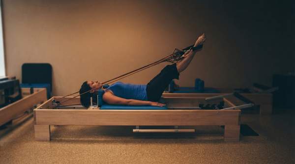 Editorial illustration for Pilates, Barre, or Spin? Matching Your Fitness Goals to the Right St. Louis Studio